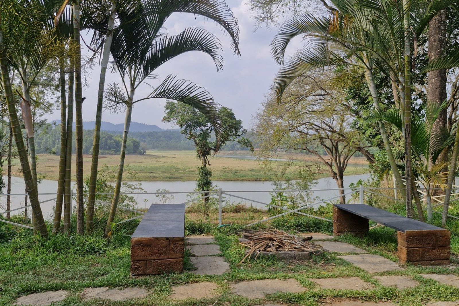 Riverside campfire corner with bench seating at Grace Backwater Villa